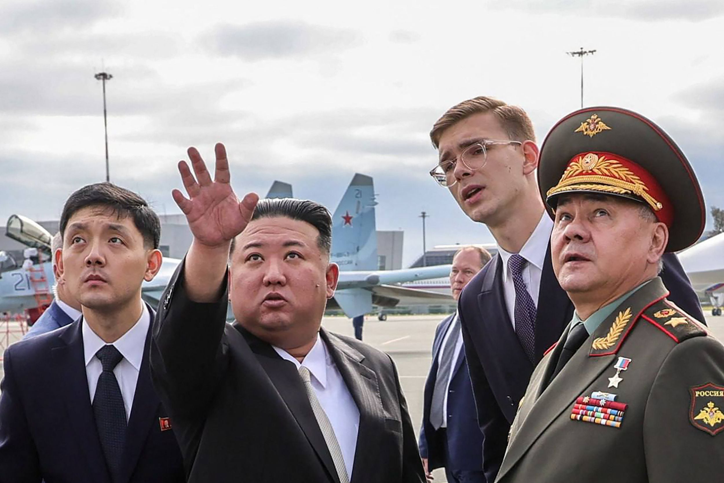El líder de Corea del Norte, Kim Jong Un (segundo por la izquierda) examinó imágenes de bases estadounidenses en la isla de Guam, en el Pacífico, que fueron tomadas por el nuevo satélite de vigilancia lanzado esta semana.