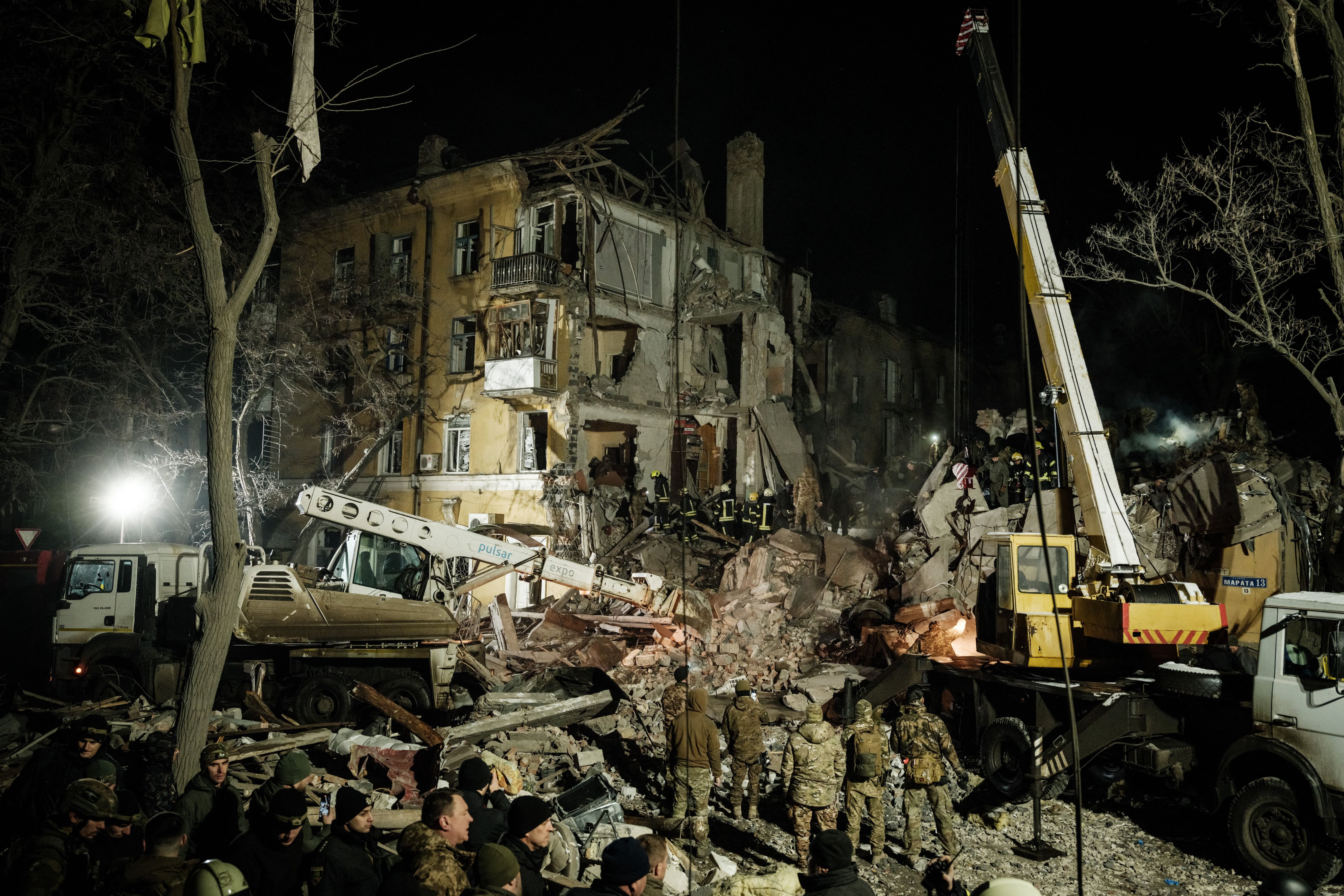 Los rescatistas retiran escombros para buscar sobrevivientes en un edificio de apartamentos destruido alcanzado por un cohete durante la noche el 1 de febrero de 2023, en medio de la invasión rusa de Ucrania.