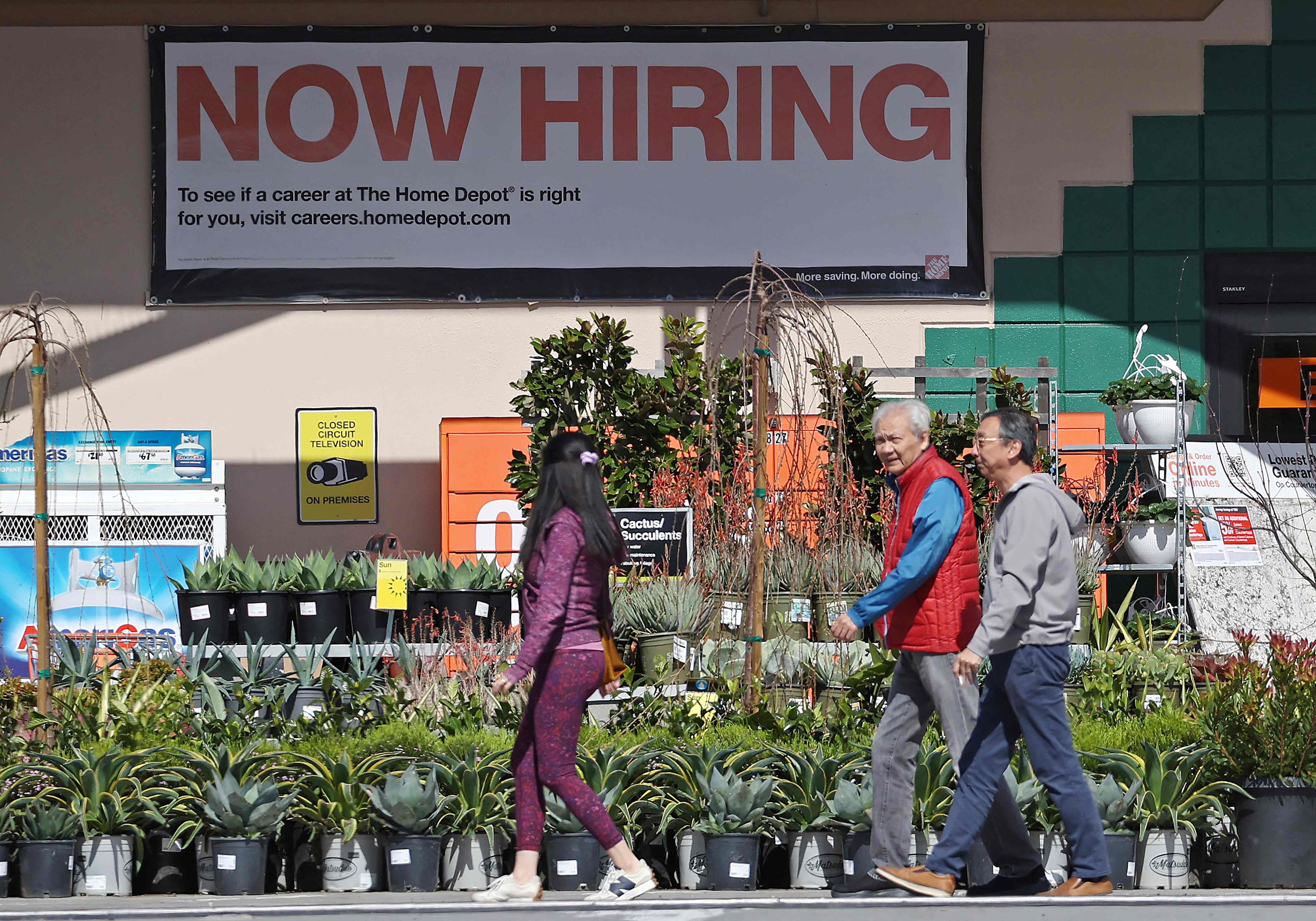 Los clientes de Home Depot pasan junto a un cartel de contratación inmediata, en San Rafael, California. Archivo:
