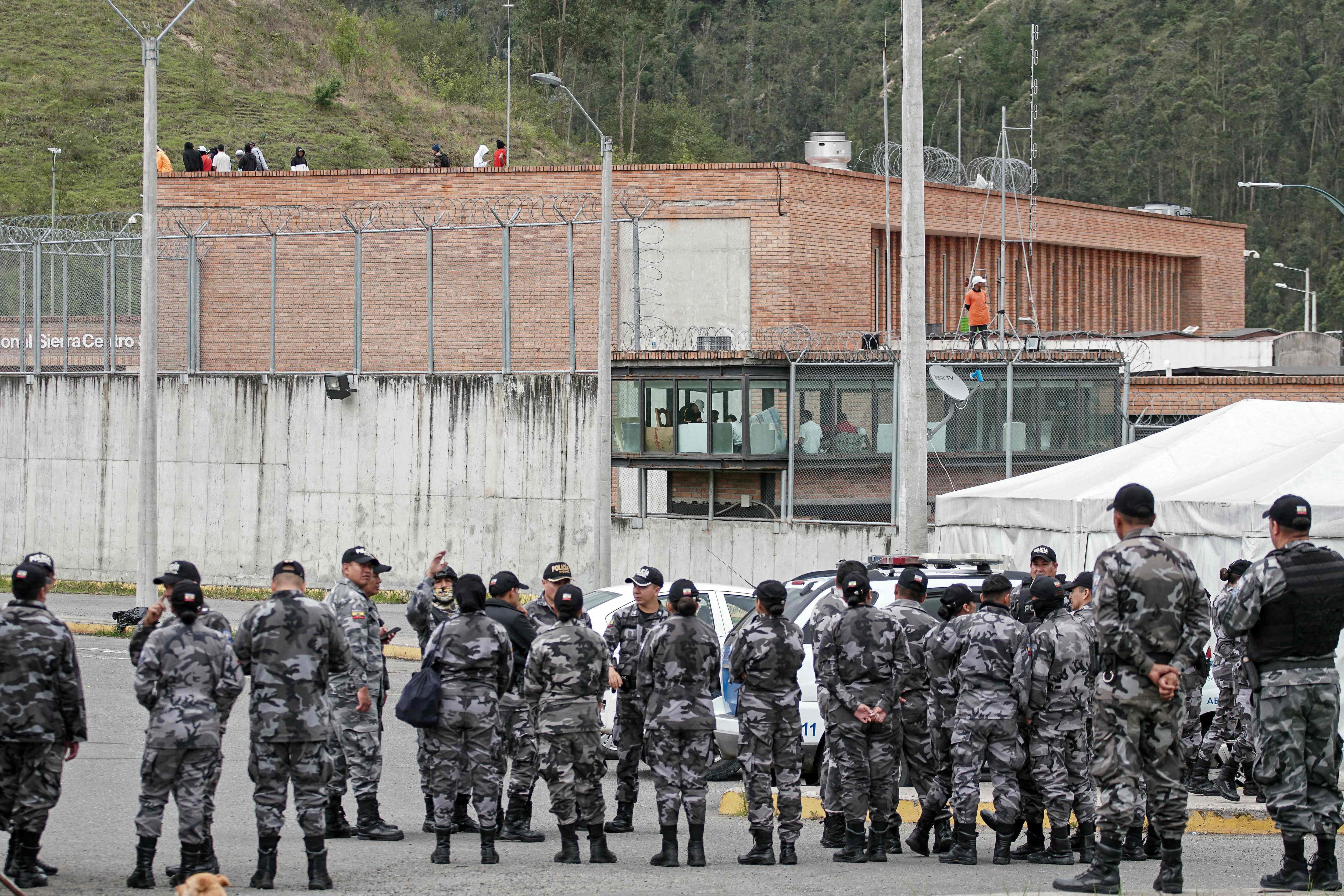 Las fuerzas policiales hacen guardia afuera de la prisión de Turi mientras los reclusos mantienen como rehenes a los guardias de la prisión, en Cuenca. Se cree que el líder de la principal banda criminal de Ecuador, Adolfo Macías, alias 